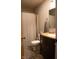 A well-lit bathroom with a shower/tub, toilet, and vanity with stone counter at 6524 Amick Way, Indianapolis, IN 46268