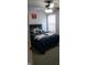 Bedroom with a blue comforter, a basketball jersey, and a ceiling fan to add modern convenience at 6524 Amick Way, Indianapolis, IN 46268