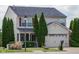 Charming two-story home with well-maintained landscaping, a two-car garage and traditional curb appeal at 6524 Amick Way, Indianapolis, IN 46268