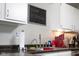 A kitchen area showing white cabinets, stainless steel sink, and blackboard accent at 6524 Amick Way, Indianapolis, IN 46268