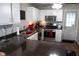 Bright kitchen featuring white cabinets, stainless steel appliances, and modern lighting at 6524 Amick Way, Indianapolis, IN 46268