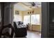 Bright sunroom with hardwood floors, yellow walls, and multiple windows allowing natural light at 6524 Amick Way, Indianapolis, IN 46268