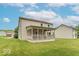 Two-story home's backyard featuring a covered porch and well-maintained lawn at 6937 Thousand Oaks Dr, Indianapolis, IN 46214