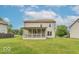 Two-story home's expansive backyard featuring a covered porch and well-maintained lawn at 6937 Thousand Oaks Dr, Indianapolis, IN 46214