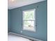 Bedroom with blue walls, a window, and neutral carpet, creating a serene atmosphere at 6937 Thousand Oaks Dr, Indianapolis, IN 46214