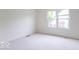 Bedroom featuring neutral carpet, white walls, and a window overlooking the backyard at 6937 Thousand Oaks Dr, Indianapolis, IN 46214