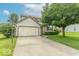 Two-story home with a two-car garage, basketball hoop, and well-maintained landscaping at 6937 Thousand Oaks Dr, Indianapolis, IN 46214