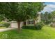 Well-maintained home with a two-car garage, lush greenery, and a serene curb appeal at 6937 Thousand Oaks Dr, Indianapolis, IN 46214