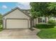 Charming home with a two-car garage, landscaped yard, and inviting entrance at 6937 Thousand Oaks Dr, Indianapolis, IN 46214