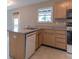 Well-lit kitchen featuring ample cabinet space, a breakfast bar, and modern appliances at 6937 Thousand Oaks Dr, Indianapolis, IN 46214