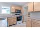 Well-lit kitchen featuring light wood cabinets, gray countertops, and modern appliances at 6937 Thousand Oaks Dr, Indianapolis, IN 46214