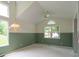 Bright living room with a vaulted ceiling, large windows, and neutral-toned walls at 6937 Thousand Oaks Dr, Indianapolis, IN 46214