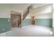 Spacious living room with a staircase, large windows, and a cozy atmosphere at 6937 Thousand Oaks Dr, Indianapolis, IN 46214