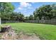Spacious backyard featuring a well-maintained lawn and a sturdy wooden fence at 7113 Chandler Dr, Indianapolis, IN 46217