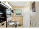 Well-lit bathroom with a granite countertop vanity and a window providing natural light at 7113 Chandler Dr, Indianapolis, IN 46217