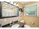 Bright bathroom featuring a granite countertop vanity and a window providing natural light at 7113 Chandler Dr, Indianapolis, IN 46217
