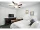 Cozy bedroom with ceiling fan, dresser with TV, and comfortable bed at 7113 Chandler Dr, Indianapolis, IN 46217