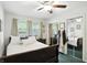 Comfortable bedroom with dark wood furniture, a ceiling fan, and mirrored closets at 7113 Chandler Dr, Indianapolis, IN 46217