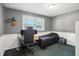 Neutral bedroom featuring a desk, computer, and bed, offering a versatile living space at 7113 Chandler Dr, Indianapolis, IN 46217