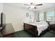 Cozy bedroom with dark wood furniture, a ceiling fan and lots of natural light at 7113 Chandler Dr, Indianapolis, IN 46217