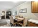 Dining area featuring a wood table with seating for six, set with decorative accents and ample natural light at 7113 Chandler Dr, Indianapolis, IN 46217