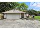 Detached two-car garage with adjacent patio and backyard at 7113 Chandler Dr, Indianapolis, IN 46217