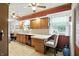 Functional kitchen with warm wood cabinetry, a breakfast bar, and durable laminate flooring at 7113 Chandler Dr, Indianapolis, IN 46217