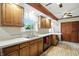 Charming kitchen featuring wooden cabinets, modern countertops, and a window offering natural light at 7113 Chandler Dr, Indianapolis, IN 46217