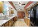 Bright kitchen showcasing wooden cabinetry, modern appliances, and wood-look flooring at 7113 Chandler Dr, Indianapolis, IN 46217
