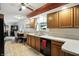 Well-lit kitchen featuring wood cabinetry, a double sink, and views into the dining space at 7113 Chandler Dr, Indianapolis, IN 46217