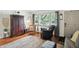 Cozy living room featuring hardwood floors, a comfortable armchair, and bright natural light at 7113 Chandler Dr, Indianapolis, IN 46217