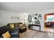Bright living room with a comfortable sofa, decorative shelves, and an adjacent dining area at 7113 Chandler Dr, Indianapolis, IN 46217
