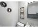Cozy powder room with stylish decor, featuring decorative mirrors and framed wall art at 7113 Chandler Dr, Indianapolis, IN 46217