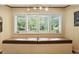 Bright sitting area with a storage bench under a large window with backyard views at 7113 Chandler Dr, Indianapolis, IN 46217