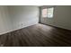 A clean, empty bedroom featuring new LVP flooring and a window at 7220 Village Pkwy Dr # 3, Indianapolis, IN 46254