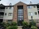 Attractive multi-story condo building with brick facade, large windows, and well-maintained landscaping at 7220 Village Pkwy Dr # 3, Indianapolis, IN 46254