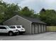 A view of the attached garages to the building with a new fence alongside at 7220 Village Pkwy Dr # 3, Indianapolis, IN 46254