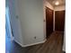 Hallway with wood-look flooring, coat closet and view to other rooms in the unit at 7220 Village Pkwy Dr # 3, Indianapolis, IN 46254