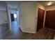 Hallway with wood-look flooring, coat closet and view to other rooms in the unit at 7220 Village Pkwy Dr # 3, Indianapolis, IN 46254