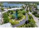 Aerial view of NewPort Bay Condominiums highlighting the tranquil pond and water features surrounded by lush greenery and community spaces at 7601 Newport Bay Dr # 115, Indianapolis, IN 46240