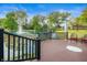 Serene backyard setting with a pond, fountain, waterfall, and wooden deck with chairs at 7601 Newport Bay Dr # 115, Indianapolis, IN 46240