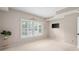 Bedroom with plantation shutters and a mounted TV at 7601 Newport Bay Dr # 115, Indianapolis, IN 46240