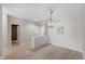 Open-concept dining room boasts beautiful wood floors, modern lighting, and ample natural light at 7601 Newport Bay Dr # 115, Indianapolis, IN 46240