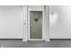 Stylish front door with decorative wreath, flanked by white pillars and a modern wall sconce at 7601 Newport Bay Dr # 115, Indianapolis, IN 46240