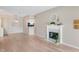 Open-concept living room with hardwood floors, fireplace and pass-through to the kitchen at 7601 Newport Bay Dr # 115, Indianapolis, IN 46240