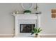 Living room featuring a decorative fireplace, mantle, and mosaic tile at 7601 Newport Bay Dr # 115, Indianapolis, IN 46240