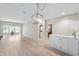 Spacious living room with hardwood floors, modern lighting, and a built-in cabinet at 7601 Newport Bay Dr # 115, Indianapolis, IN 46240