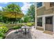Relaxing outdoor patio area with table and chairs, offering views of the backyard pond and fountain at 7601 Newport Bay Dr # 115, Indianapolis, IN 46240