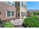 Inviting patio features stone paving, garden beds, seating, and access to the home's exterior at 7601 Newport Bay Dr # 115, Indianapolis, IN 46240