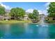 Beautiful community pond with fountain surrounded by landscaping and residences at 7601 Newport Bay Dr # 115, Indianapolis, IN 46240